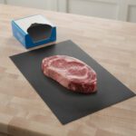 Black Steak Paper 10" x 30" shown with steak on sheet