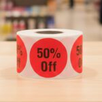 50 percent off sticker on a round red label with black text