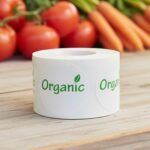 organic label on a round white sticker with green print and a leaf above the I