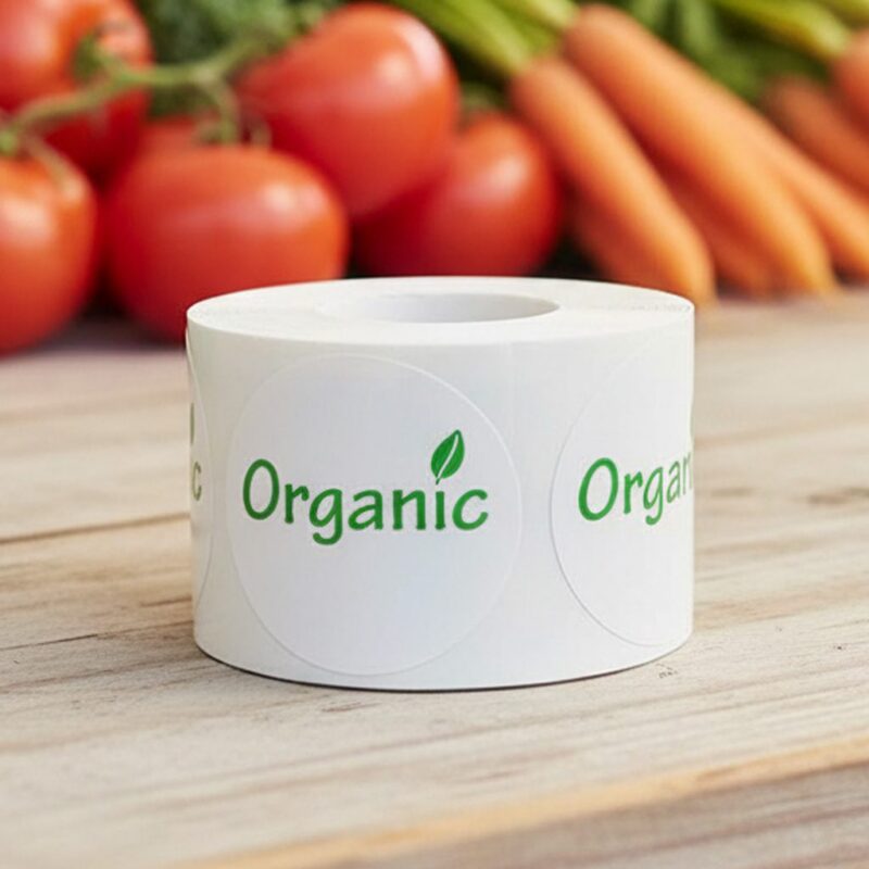 organic label on a round white sticker with green print and a leaf above the I