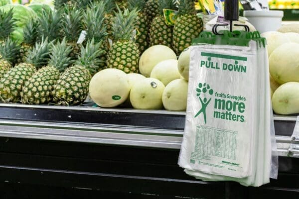 Produce Header Bag on Rack in front of fruits