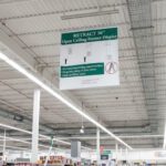 Ceiling Banner Display retractable sign with stabilizer for wide sign shown attached to ceiling