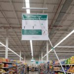 Ceiling Banner Display retractable sign with stabilizer for wide sign shown being pulled down