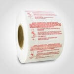 Safe Handling Label with red text on roll of stickers