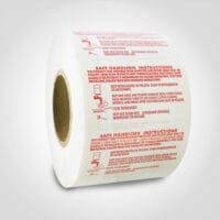 Safe Handling Label with red text on roll of stickers