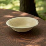 Palm Leaf Wood Bowl 6oz shown on a table