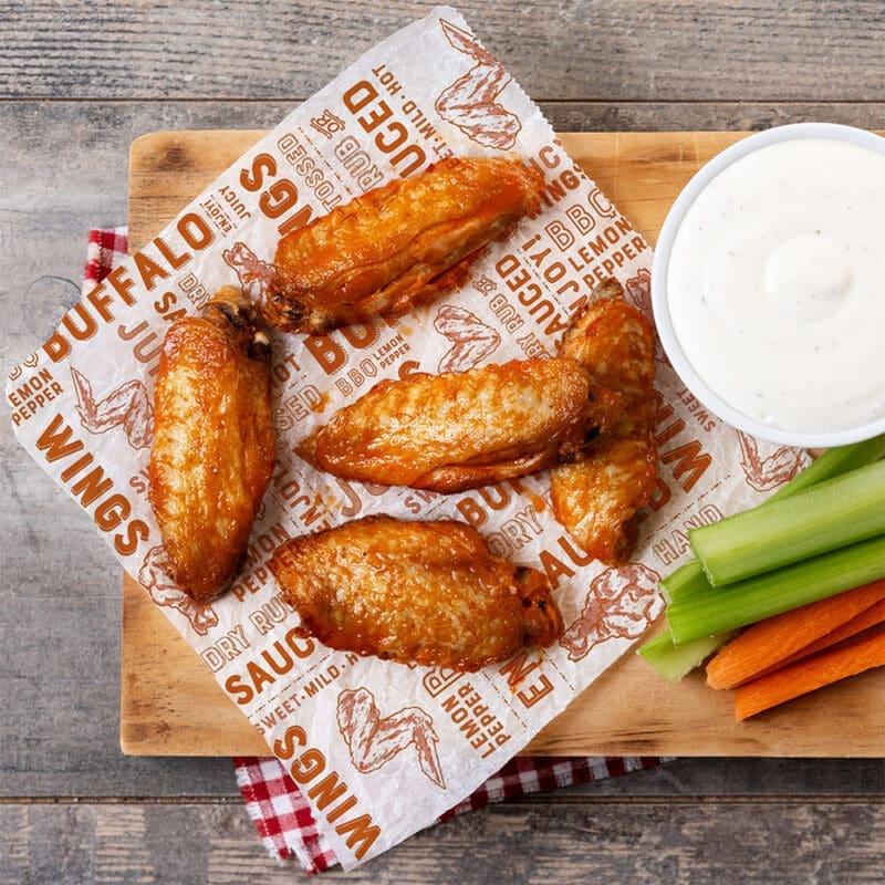 Buffalo Chicken Wings sitting on Wings Paper Wrap
