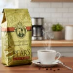 Pear's Coffee French Roast 24oz next to a cup of coffee