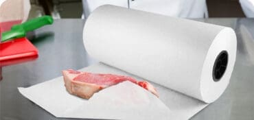 Butcher paper roll on butcher table with steak