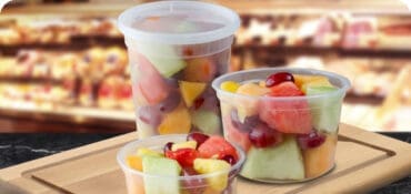 Deli Containers on a Deli Countertop with fruit inside the containers