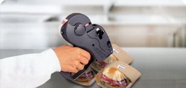 Monarch Price Marking Labeler putting prices on sandwiches in bags