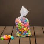small popcorn bag with colorful popcorn inside on a table