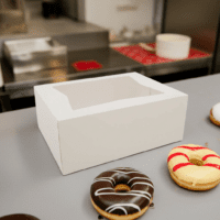 Donut Box with Window 10.25" x 8" x 4" sitting next to donuts