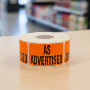 As Advertised sticker on a rectangle orange label with black text