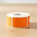Blank orange rectangle sticker on a roll of labels