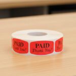 paid thank you sticker on a red label with black text