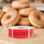 glazed label on a rectangle red label with black text in front of glazed donuts